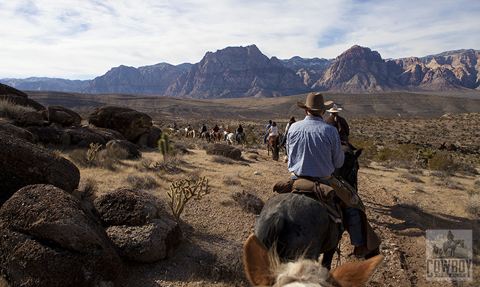 Thanksgiving Day ride with the Wilson cliffs in the background taken while Horseback Riding in Las Vegas at Cowboy Trail Rides in Red Rock Canyon while Horseback Riding in Las Vegas at Cowboy Trail Rides in Red Rock Canyon